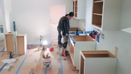 Lofty Built carpenter installing cabinets